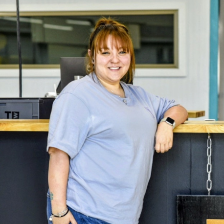 Alyssa smiling by the front desk