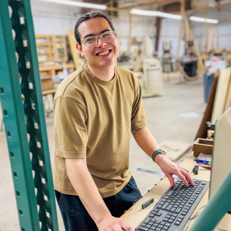 Mikey smiling in the wood shop